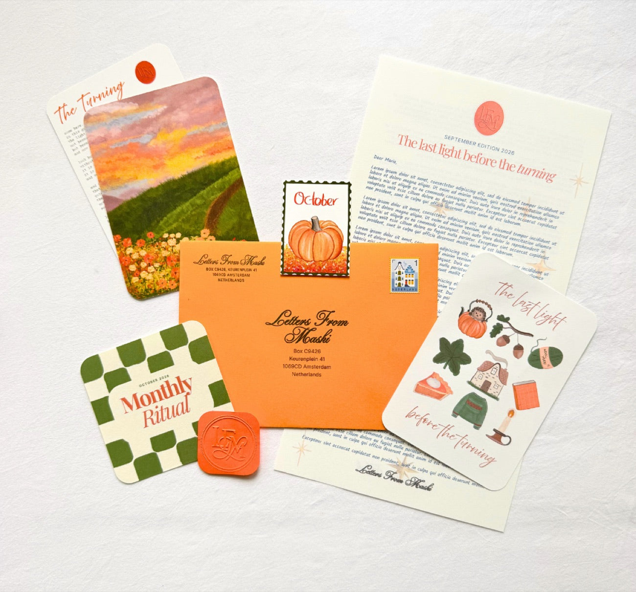The October Letters from Mashi edition laid out — the orange themed envelope, autumn letter, pumpkin stamp, wax seal, sticker sheet, sunset art print, and Monthly Ritual card