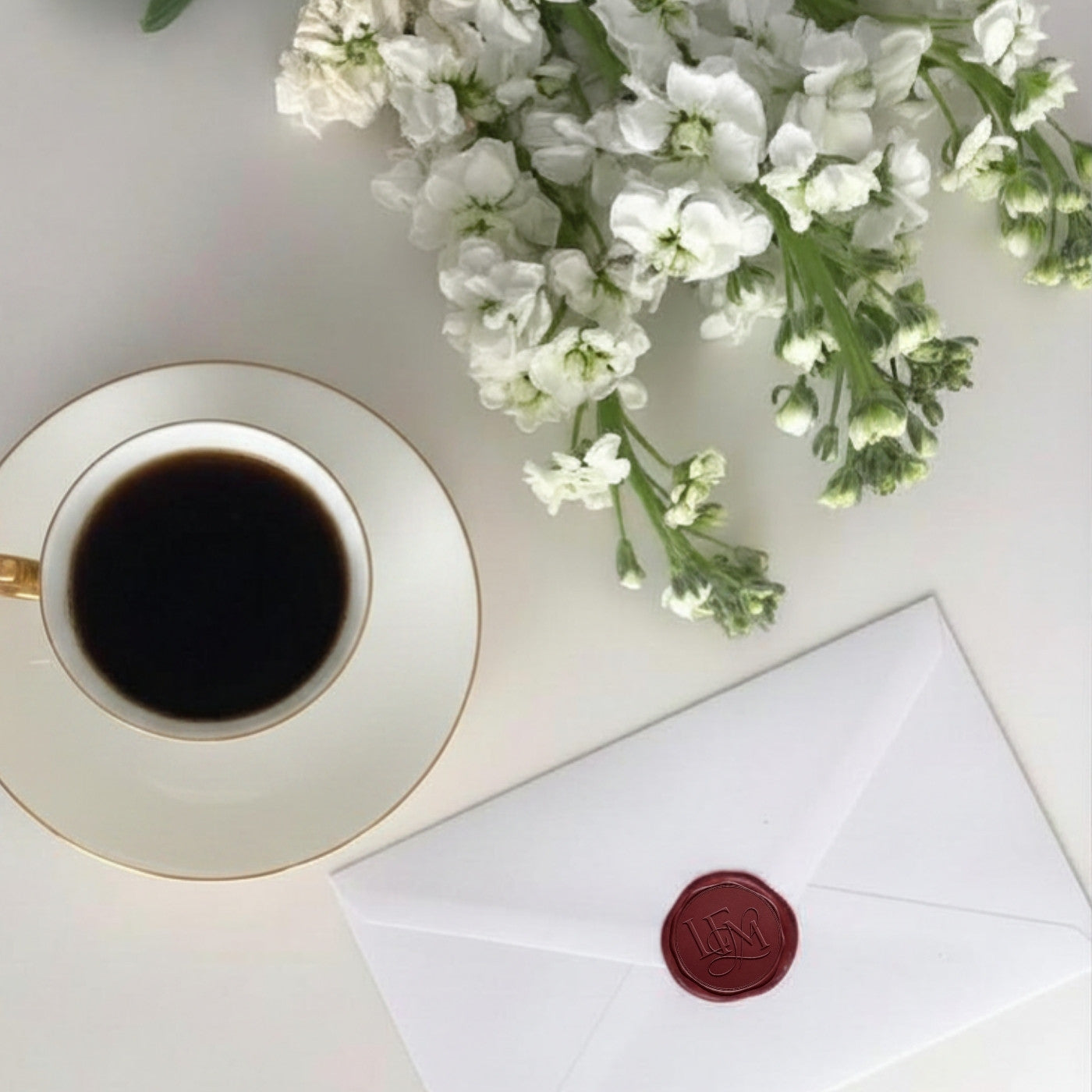 An envelope and print laid out on linen